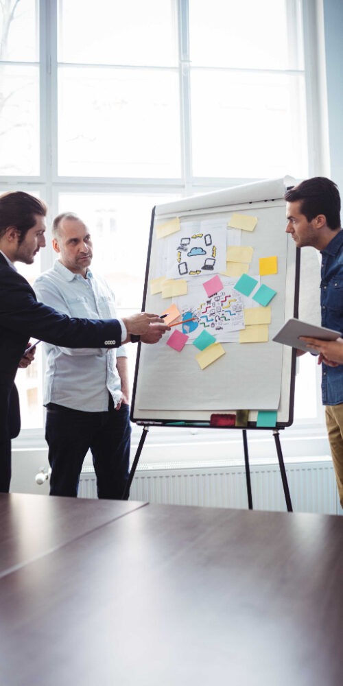 coworkers-discussing-meeting-room